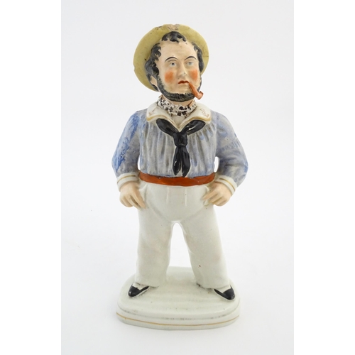 68 - A Staffordshire pottery model of a sailor smoking a pipe. Approx. 13