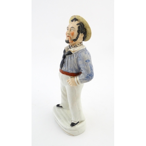 68 - A Staffordshire pottery model of a sailor smoking a pipe. Approx. 13