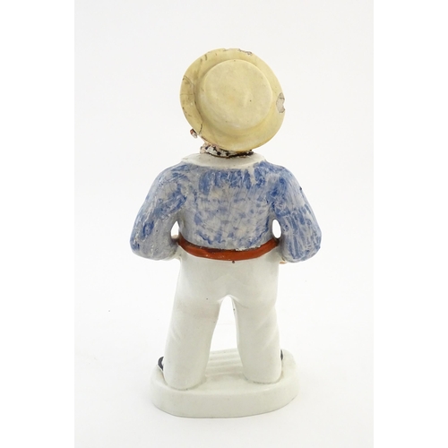 68 - A Staffordshire pottery model of a sailor smoking a pipe. Approx. 13