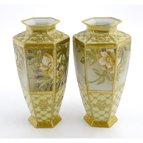 7 - A pair of Japanese Noritake vases of hexagonal form decorated with flowers and foliage with gilt hig... 