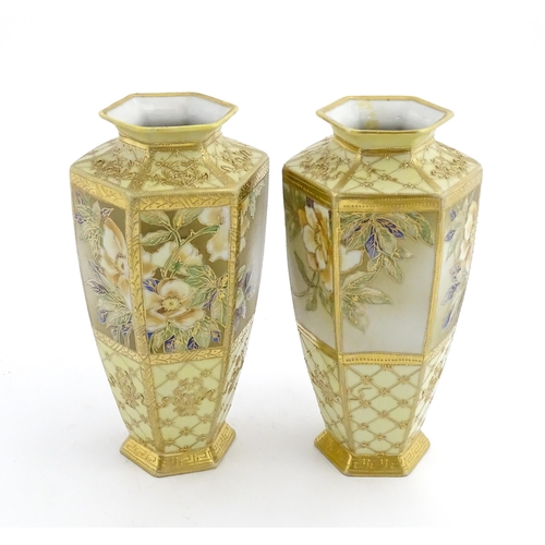 7 - A pair of Japanese Noritake vases of hexagonal form decorated with flowers and foliage with gilt hig... 