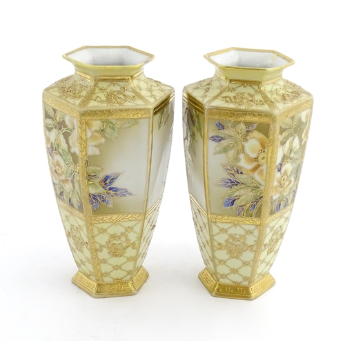 7 - A pair of Japanese Noritake vases of hexagonal form decorated with flowers and foliage with gilt hig... 