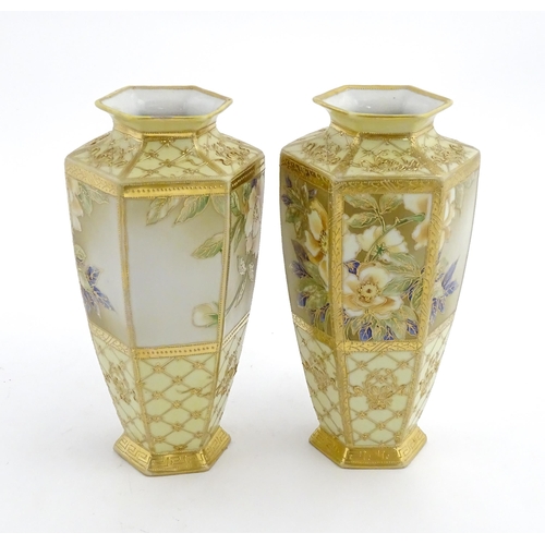 7 - A pair of Japanese Noritake vases of hexagonal form decorated with flowers and foliage with gilt hig... 