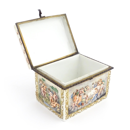 72 - A Capodimonte porcelain casket / box decorated in relief with Bacchanalian scenes, to include huntin... 