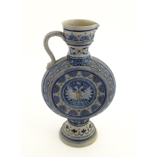 75 - A German Westerwald salt glazed ewer / flask with double headed eagle detail. Impressed under 566A. ... 