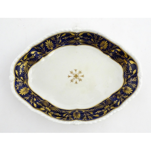 84 - A Derby dish of shaped form with cobalt blue border with gilt foliate decoration. Together with a Co... 