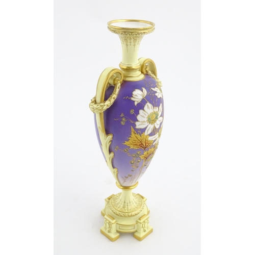 87 - A Royal Worcester cream and purple vase of pedestal baluster form with twin gilt acanthus leaf handl... 