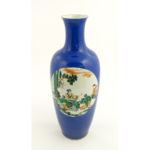 9 - A large Chinese famille verte vase with a blue ground decorated with scholar figures with a sage in ... 