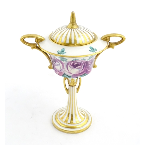 91 - A Minton Art Nouveau twin handled pedestal urn and cover with twin handles, the body with hand paint... 