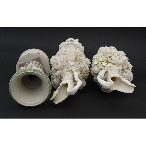 92 - A pair of Samuel Alcock bisque / parian ewers with decorated with encrusted flowers and relief bunch... 