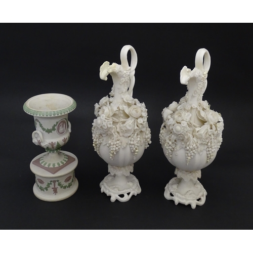 92 - A pair of Samuel Alcock bisque / parian ewers with decorated with encrusted flowers and relief bunch... 