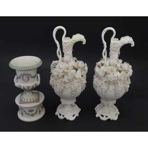 92 - A pair of Samuel Alcock bisque / parian ewers with decorated with encrusted flowers and relief bunch... 