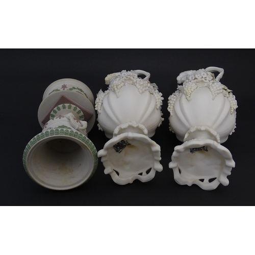 92 - A pair of Samuel Alcock bisque / parian ewers with decorated with encrusted flowers and relief bunch... 