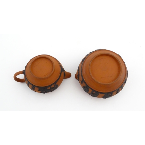 93 - A quantity of Wedgwood Rosso Antico / terracotta jasperware tea wares with applied black Classical f... 