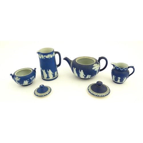 94 - A quantity of Wedgwood dark blue jasperware tea wares with applied white Classical figures and motif... 