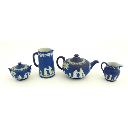 94 - A quantity of Wedgwood dark blue jasperware tea wares with applied white Classical figures and motif... 