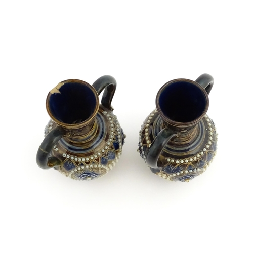 99 - A pair of Doulton Lambeth twin handled vases with roundel detail. Marked under and numbered 448. App... 