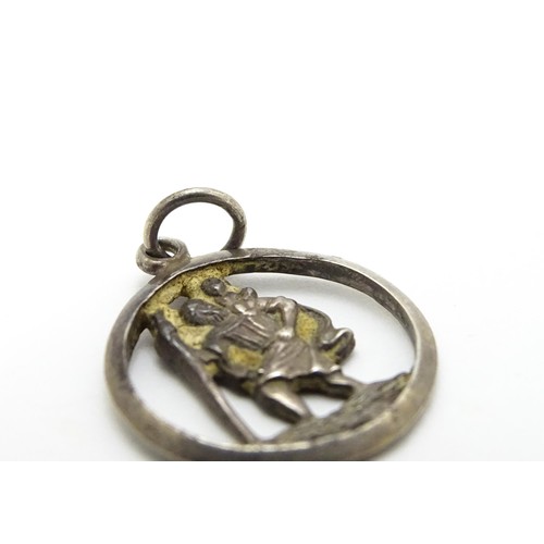 671 - A Continental silver pendant depicting St Christopher. Together with another. Largest approx. 1