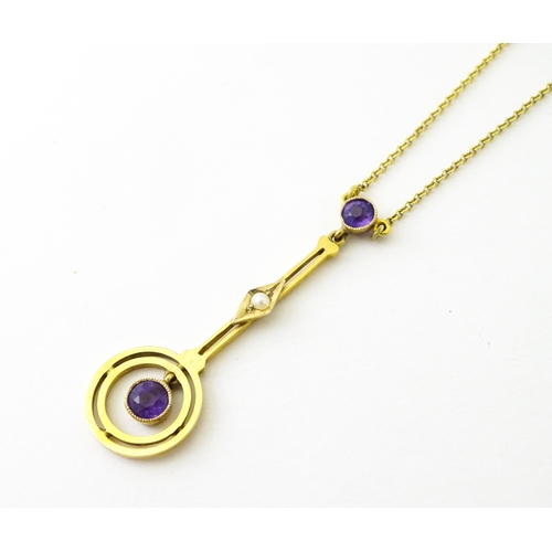 740 - A yellow metal pendant and chain set with amethyst and pearl. Approx 16