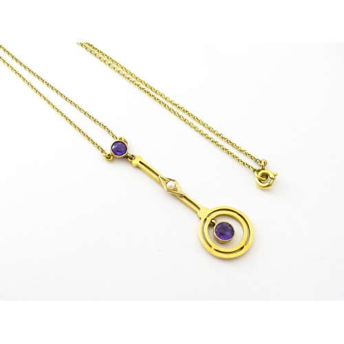 740 - A yellow metal pendant and chain set with amethyst and pearl. Approx 16