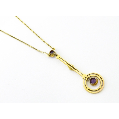 740 - A yellow metal pendant and chain set with amethyst and pearl. Approx 16