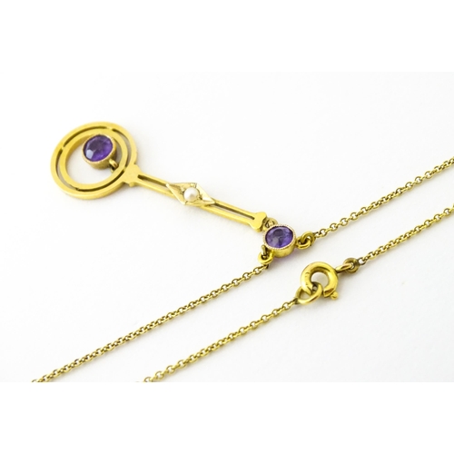 740 - A yellow metal pendant and chain set with amethyst and pearl. Approx 16