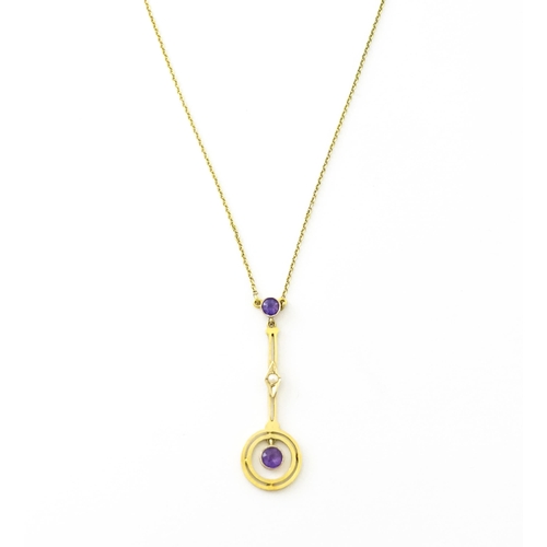 740 - A yellow metal pendant and chain set with amethyst and pearl. Approx 16