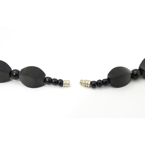 774 - A vintage necklace of graduated black beads. Approx. 28