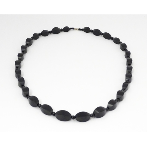 774 - A vintage necklace of graduated black beads. Approx. 28