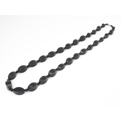 774 - A vintage necklace of graduated black beads. Approx. 28