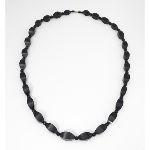 774 - A vintage necklace of graduated black beads. Approx. 28