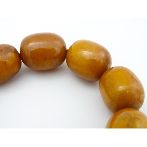 779 - A vintage necklace of amber coloured beads. Largest bead approx. 1