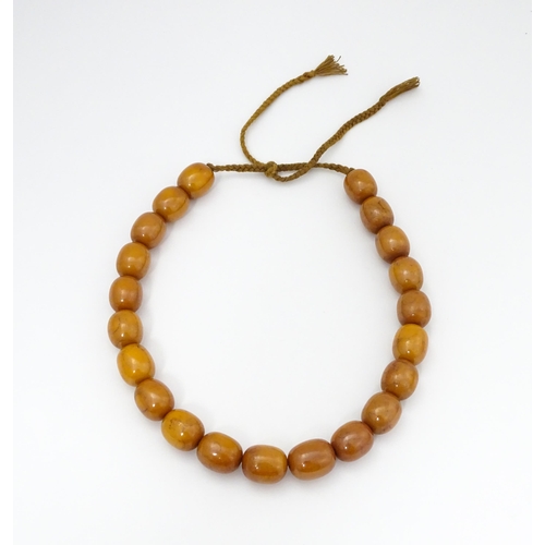 779 - A vintage necklace of amber coloured beads. Largest bead approx. 1