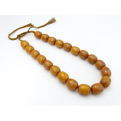 779 - A vintage necklace of amber coloured beads. Largest bead approx. 1