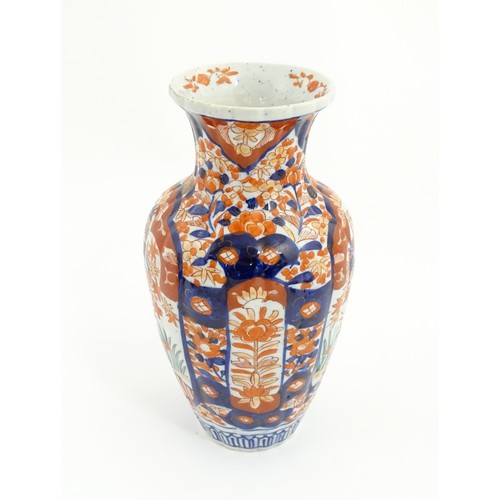 203 - A Japanese vase decorated in the Imari palette with flowers and foliage, with further floral motifs ... 