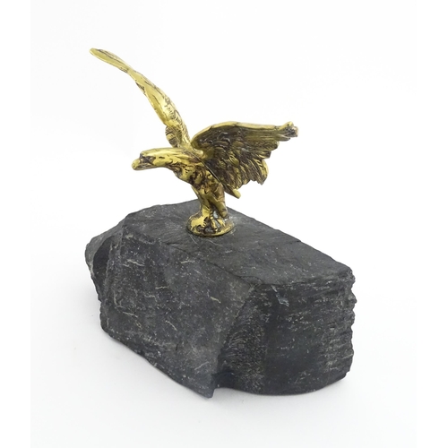 1016 - A 20thC cast brass eagle with outstretched wings mounted on a hardstone. Approx. 8 1/2