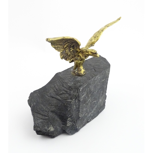 1016 - A 20thC cast brass eagle with outstretched wings mounted on a hardstone. Approx. 8 1/2