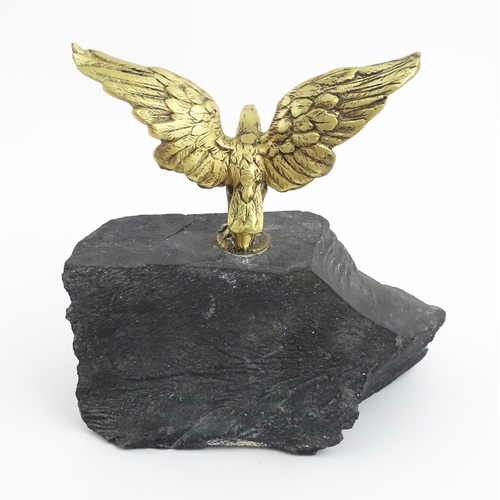 1016 - A 20thC cast brass eagle with outstretched wings mounted on a hardstone. Approx. 8 1/2