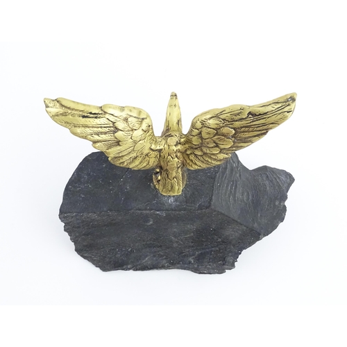 1016 - A 20thC cast brass eagle with outstretched wings mounted on a hardstone. Approx. 8 1/2