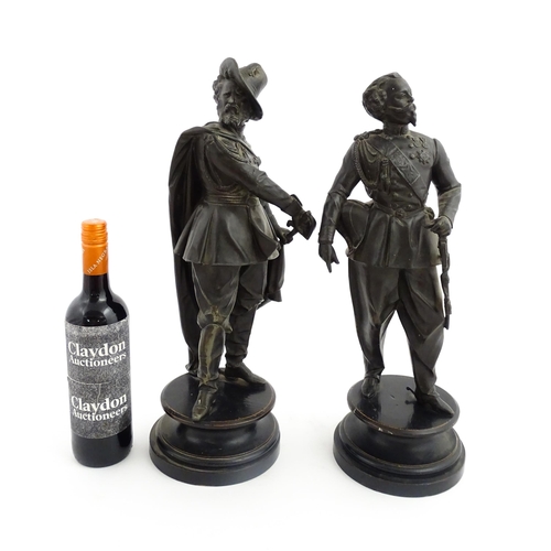 1023 - A pair of 20thC Continental cast military figures in uniform with swords, raised on turned wooden so... 