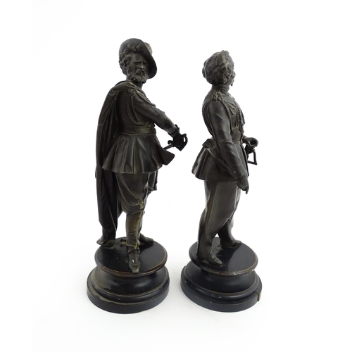 1023 - A pair of 20thC Continental cast military figures in uniform with swords, raised on turned wooden so... 