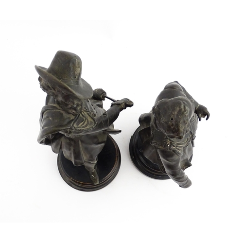 1023 - A pair of 20thC Continental cast military figures in uniform with swords, raised on turned wooden so... 