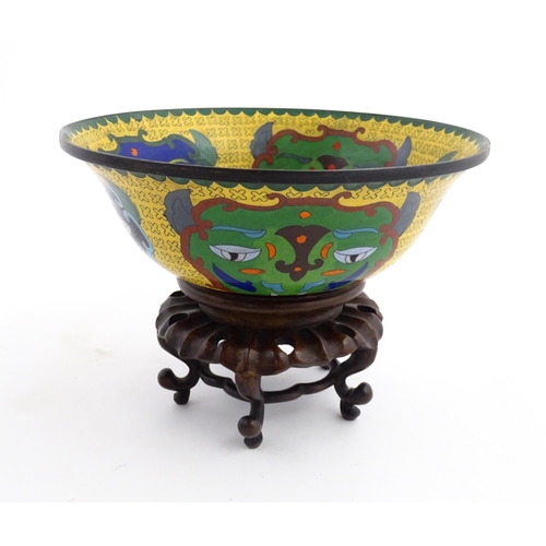 1029 - A Chinese cloisonne bowl of flared form, the yellow ground with stylised mask detail, the interior w... 