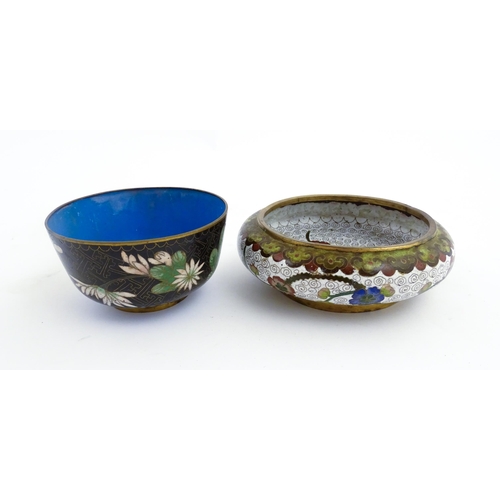 1035 - A Japanese cloisonne bowl the black ground decorated with flowers and foliate. Together with a Chine... 