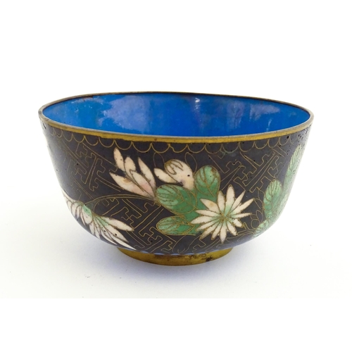 1035 - A Japanese cloisonne bowl the black ground decorated with flowers and foliate. Together with a Chine... 