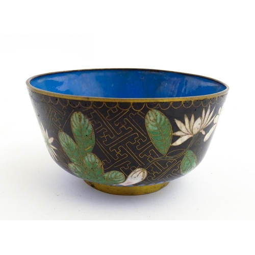 1035 - A Japanese cloisonne bowl the black ground decorated with flowers and foliate. Together with a Chine... 