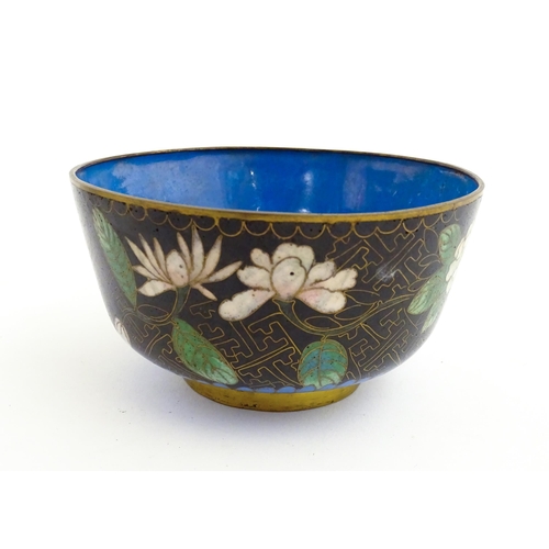 1035 - A Japanese cloisonne bowl the black ground decorated with flowers and foliate. Together with a Chine... 