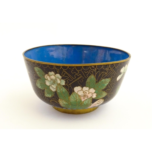 1035 - A Japanese cloisonne bowl the black ground decorated with flowers and foliate. Together with a Chine... 