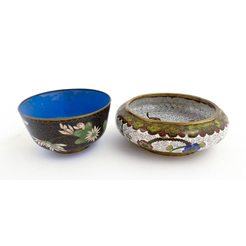 1035 - A Japanese cloisonne bowl the black ground decorated with flowers and foliate. Together with a Chine... 