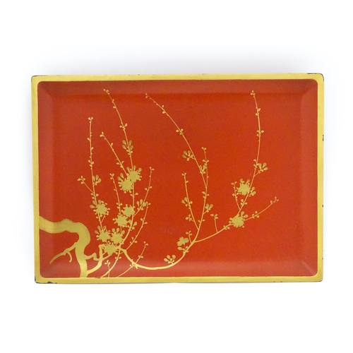 1045 - An Oriental Art Deco style red lacquer cocktail tray of rectangular form decorated with gilt blossom... 